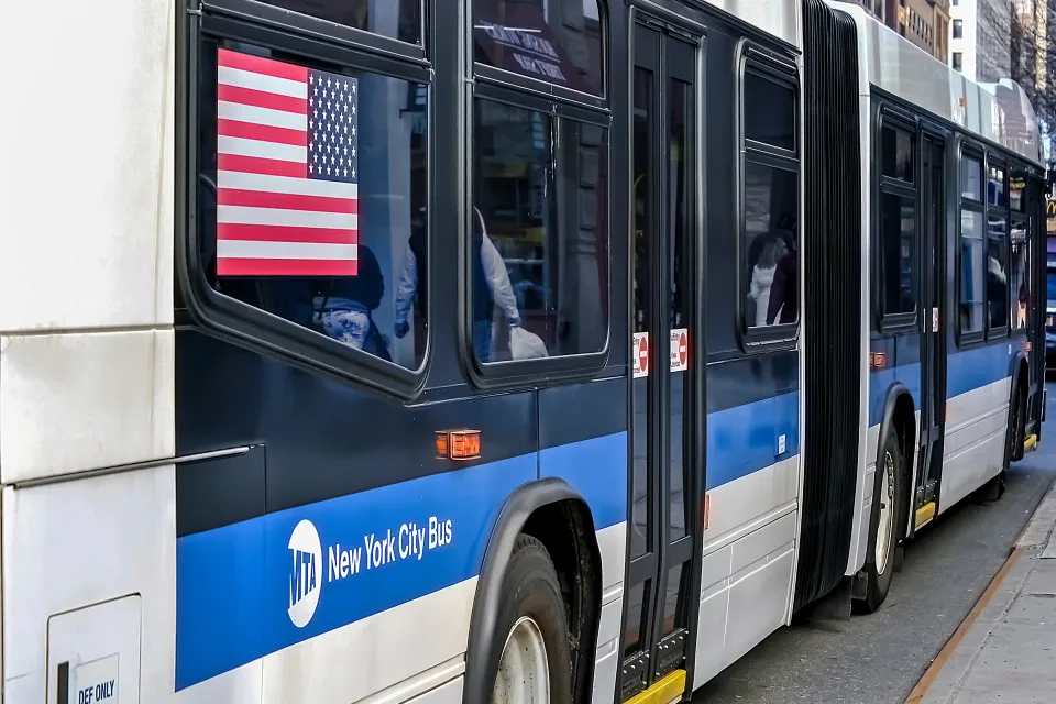 Close-up from back of blue and white New York City bus